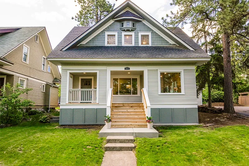 Craftsman bungalow with sage green siding and a front porch