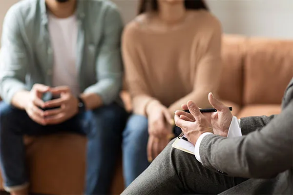 Two homeowners talking with a consultant who is taking notes